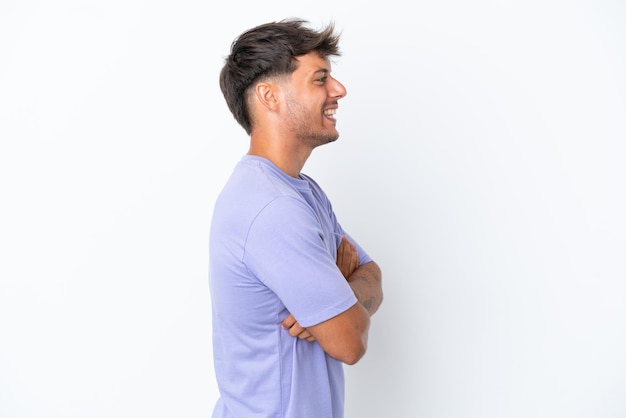 Young caucasian handsome man isolated on white background in lateral position