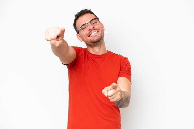 Young caucasian handsome man isolated on white background pointing front with happy expression