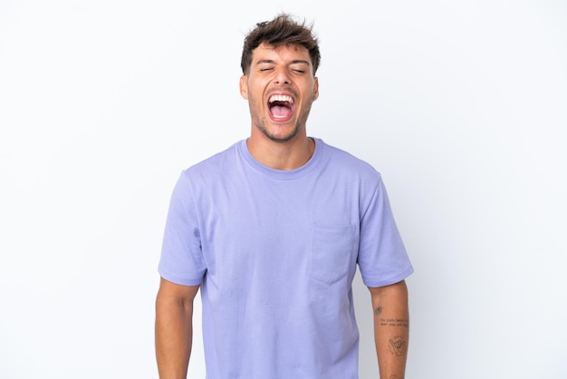 Young caucasian handsome man isolated on white background shouting to the front with mouth wide open