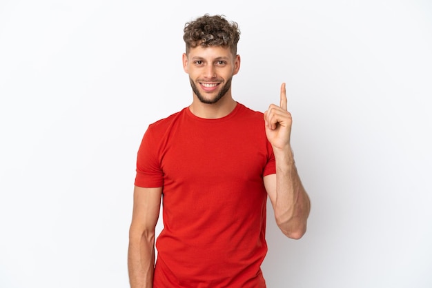 Young caucasian handsome man isolated on white background showing and lifting a finger in sign of the best