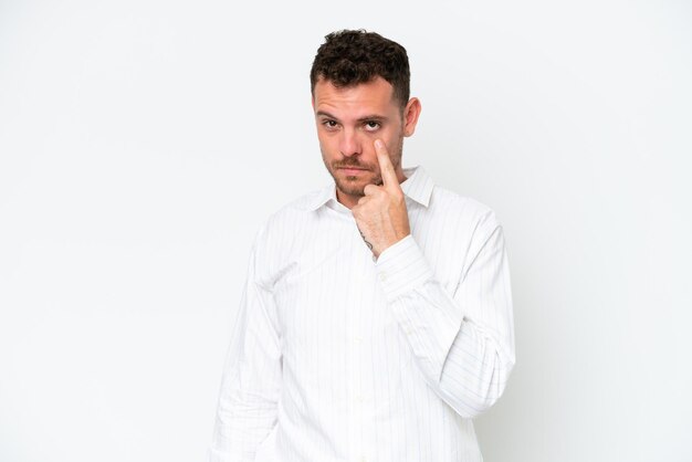 Young caucasian handsome man isolated on white background showing something