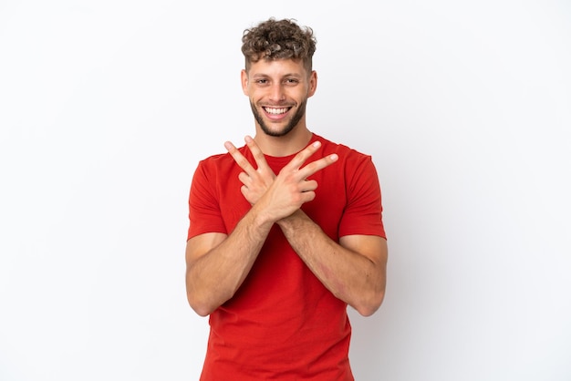 Young caucasian handsome man isolated on white background smiling and showing victory sign