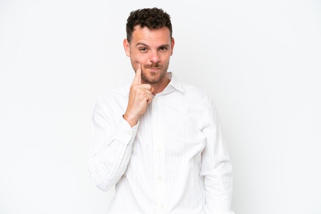 Young caucasian handsome man isolated on white background and thinking