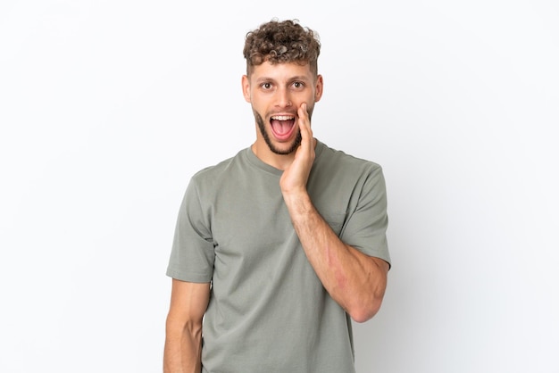 Young caucasian handsome man isolated on white background with surprise and shocked facial expression