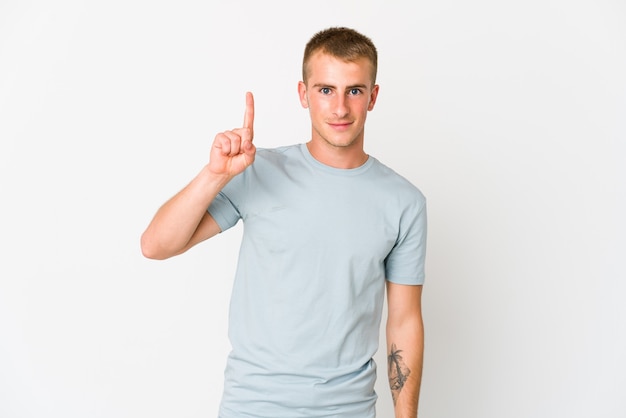 Young caucasian handsome man showing number one with finger.