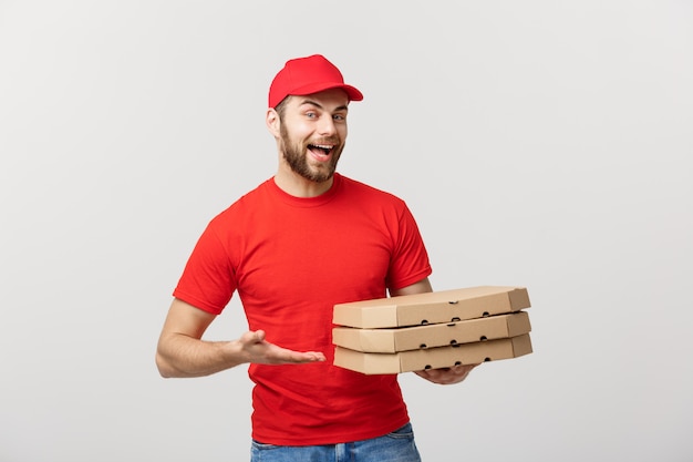 Young caucasian Handsome Pizza delivery man holding pizza boxes