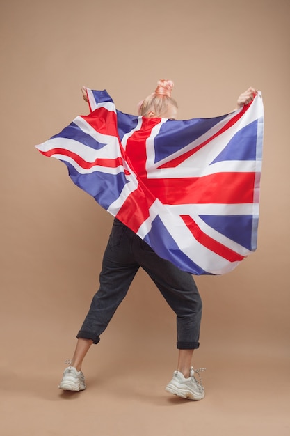 Young caucasian hipster woman with flag of Great Britain