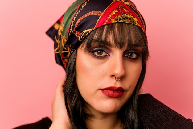 Young caucasian makeup artist woman isolated on pink background