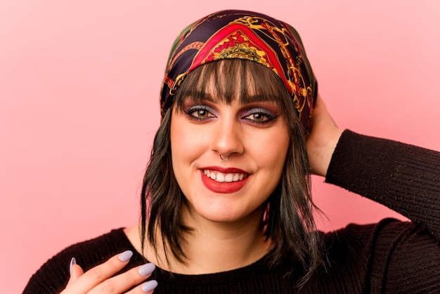 Young caucasian makeup artist woman isolated on pink background