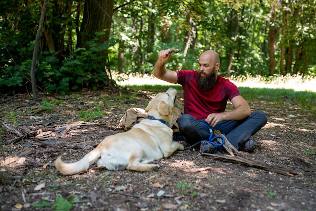 Young caucasian male tourist exploring beautiful places with his labrador retriever