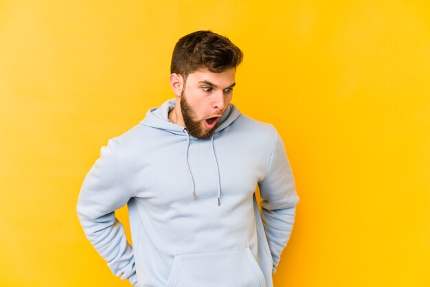 Young caucasian man being shocked because of something she has seen.