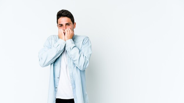 Young caucasian man biting fingernails, nervous and very anxious.