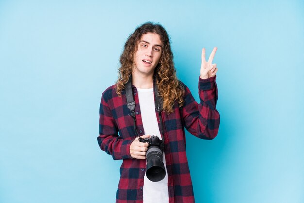 Young caucasian man on a blue wall