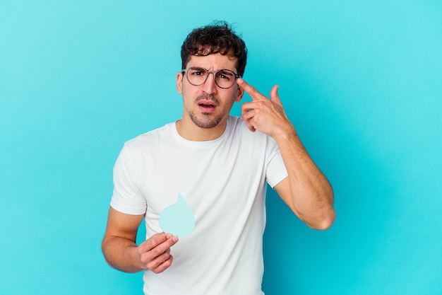 Young caucasian man celebrating world water day isolated showing a disappointment gesture with forefinger.