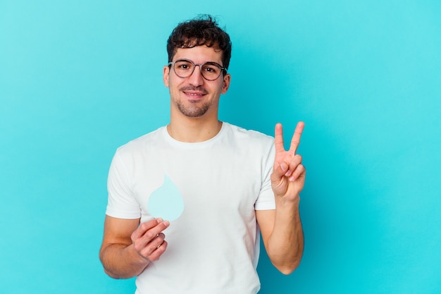 Young caucasian man celebrating world water day isolated showing number two with fingers.