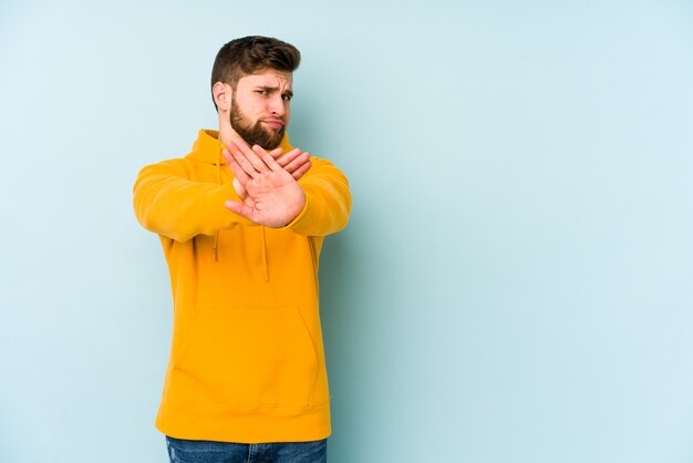 Young caucasian man doing a denial gesture