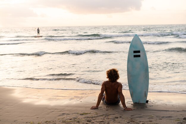 Young caucasian man get up early to  doing surf at sunrise