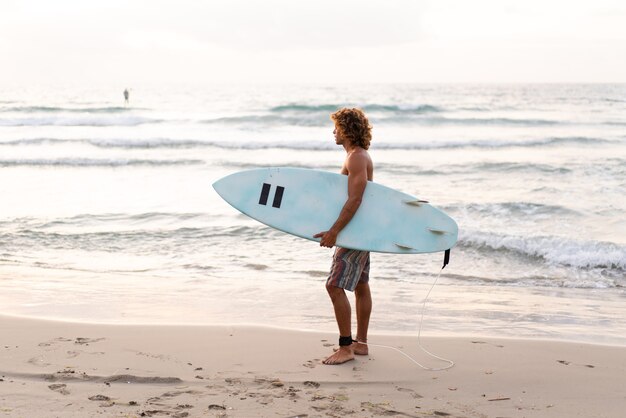 Young caucasian man get up early to  doing surf at sunrise