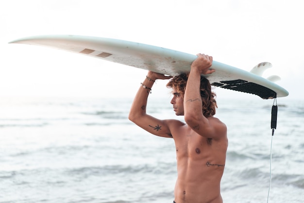 Young caucasian man get up early to  doing surf at sunrise