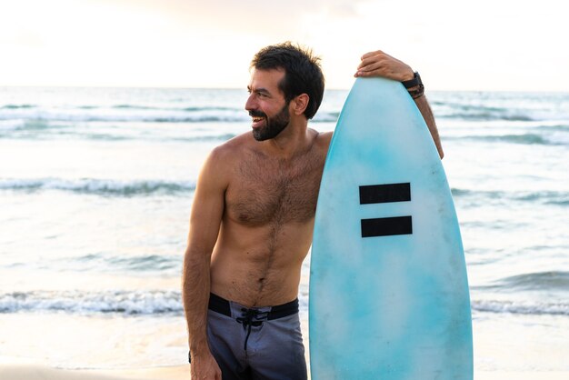 Young caucasian man get up early to  doing surf at sunrise