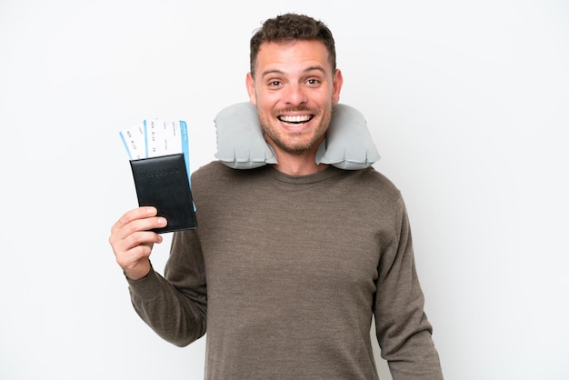 Young caucasian man holding a passport isolated on white background with surprise facial expression