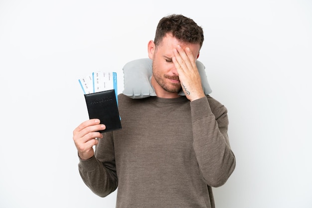 Young caucasian man holding a passport isolated on white background with tired and sick expression