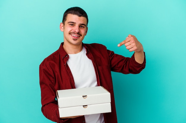 Young caucasian man holding pizzas isolated