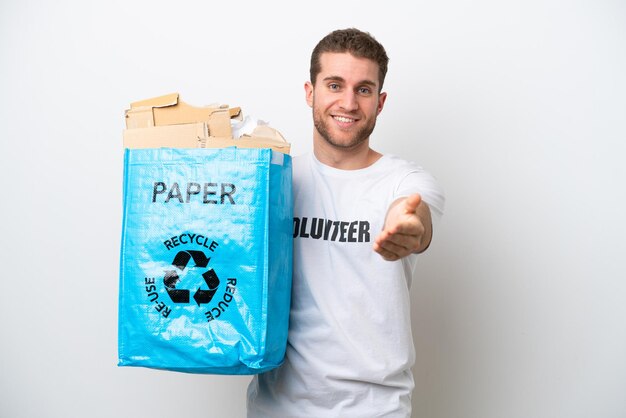 Young caucasian man holding a recycling bag full of paper to recycle isolated on white background shaking hands for closing a good deal