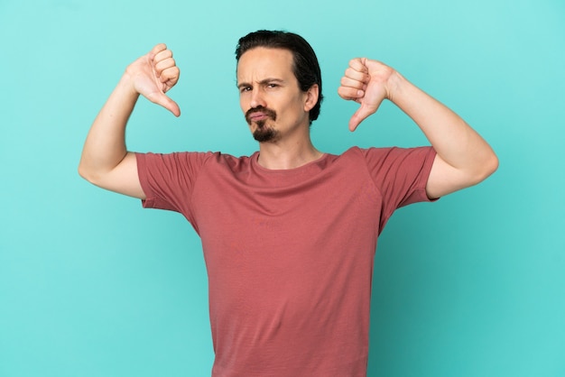 Young caucasian man isolated on blue background proud and self-satisfied