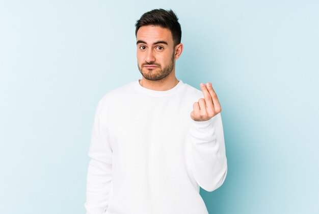 Young caucasian man isolated on blue background showing that has no money.