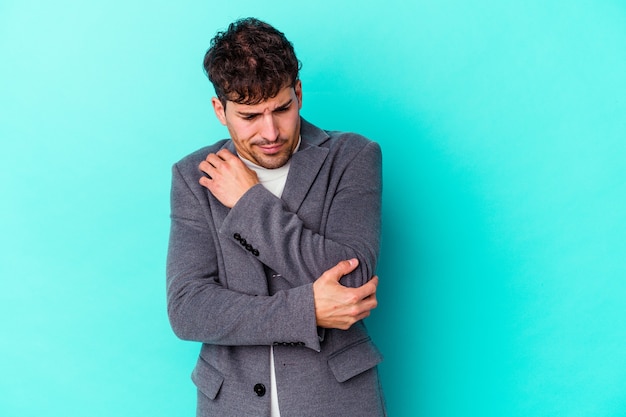 Young caucasian man isolated on blue wall confused, feels doubtful and unsure