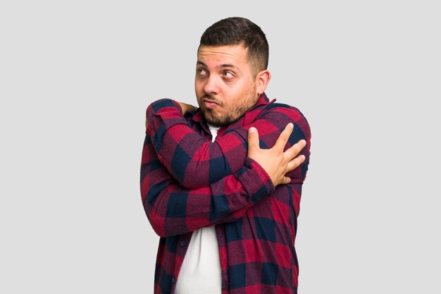 Young caucasian man isolated hugs smiling carefree and happy