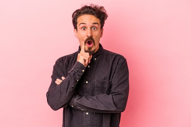 Young caucasian man isolated on pink background having some great idea, concept of creativity.