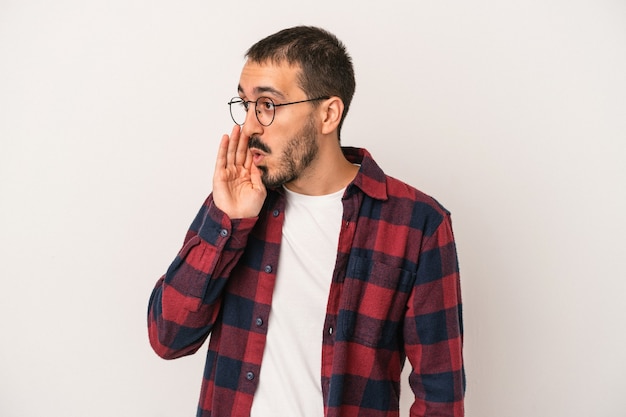 Young caucasian man isolated on white background being shocked because of something she has seen.