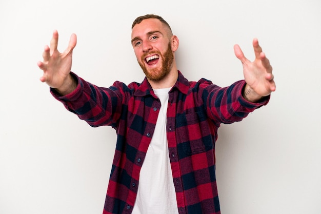 Young caucasian man isolated on white background celebrating a victory or success, he is surprised and shocked.