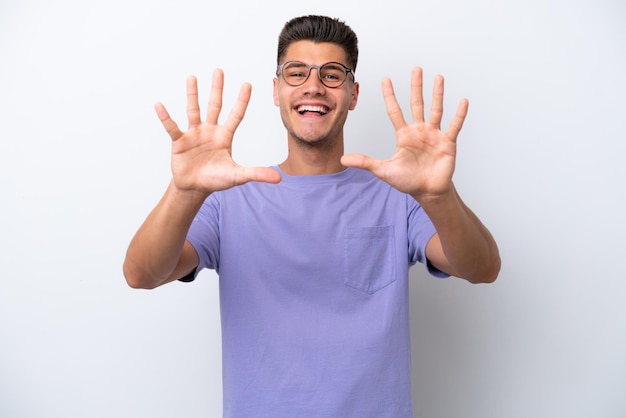 Young caucasian man isolated on white background counting ten with fingers