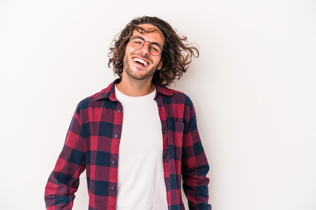 Young caucasian man isolated on white background dancing and having fun.