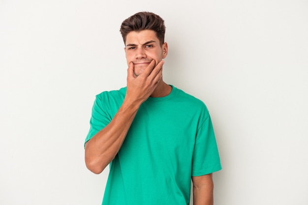 Young caucasian man isolated on white background doubting between two options.