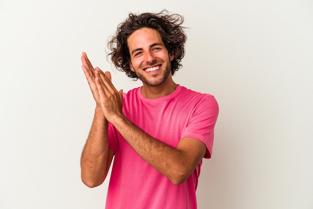 Young caucasian man isolated on white background feeling energetic and comfortable, rubbing hands confident.