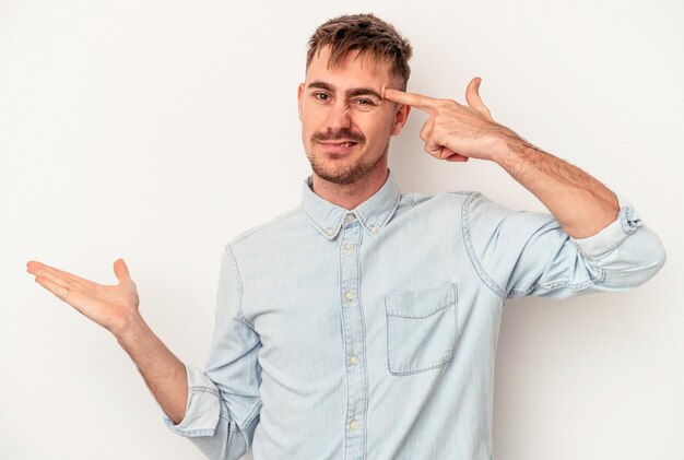 Young caucasian man isolated on white background feels confident giving a hug to the camera.