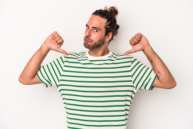 Young caucasian man isolated on white background feels proud and self confident, example to follow.