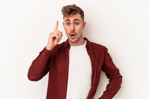 Young caucasian man isolated on white background having an idea, inspiration concept.