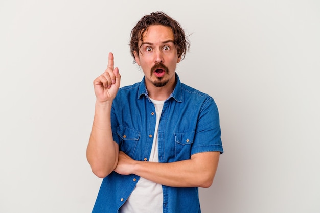 Young caucasian man isolated on white background having some great idea, concept of creativity.