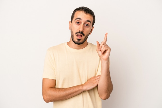 Young caucasian man isolated on white background having some great idea, concept of creativity.