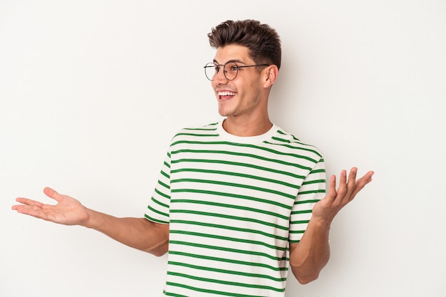 Young caucasian man isolated on white background joyful laughing a lot. Happiness concept.