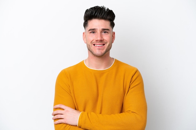 young caucasian man isolated on white background keeping the arms crossed in frontal position