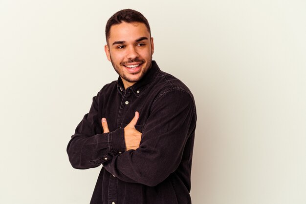 Young caucasian man isolated on white background laughing and having fun.