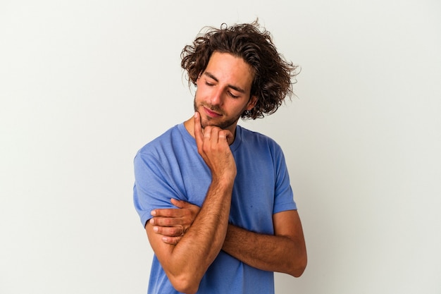 Young caucasian man isolated on white background looking sideways with doubtful and skeptical expression.