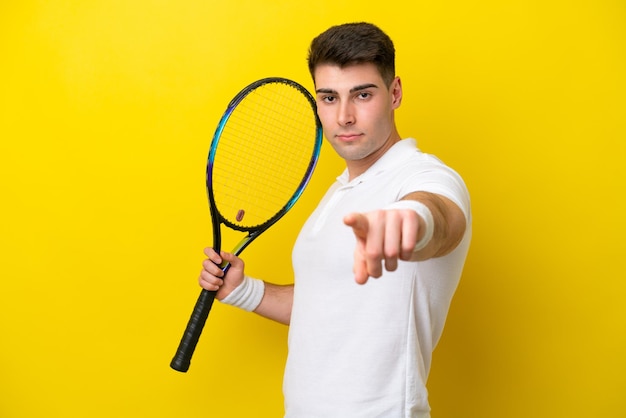 Young caucasian man isolated on white background playing tennis