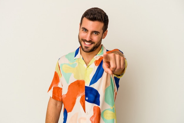 Young caucasian man isolated on white background pointing to front with fingers.